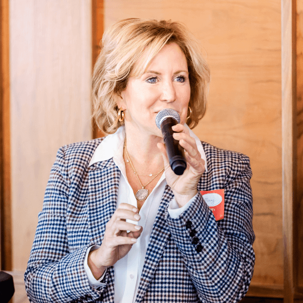 Significance founder and CEO Mary Ahern-Snyder giving a speech in a conference room