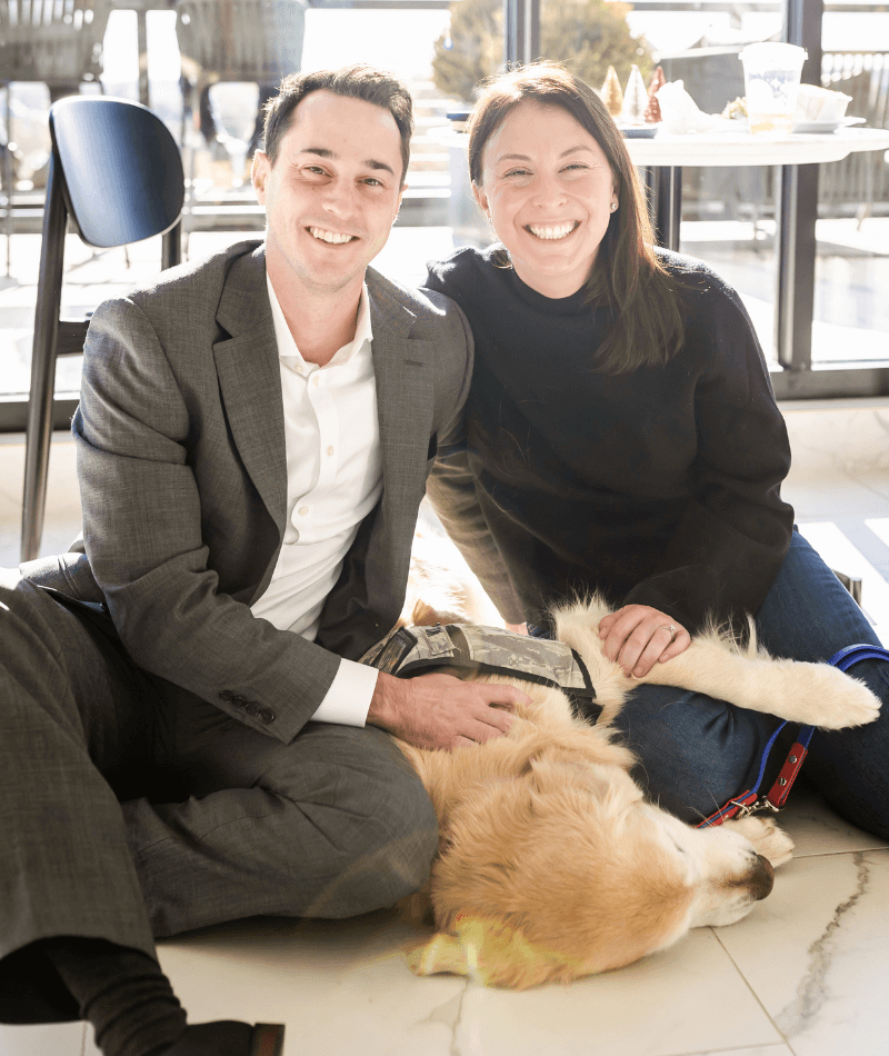 A couple from Significance Inc spending time with Warrior Canine Connection service dog