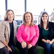 Significance CFO Lisa Snyder with colleagues on a couch